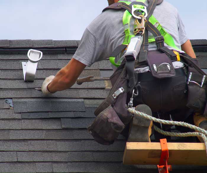 Professional Roofing Inspection & Roofing Repair Oakland Park, FL A roofing professional fixing a residential roof near Oakland Park, FL